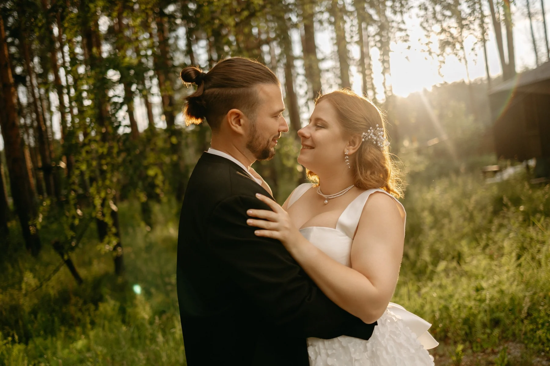 Newlyweds standing together in warm evening light in a digital wedding portrait