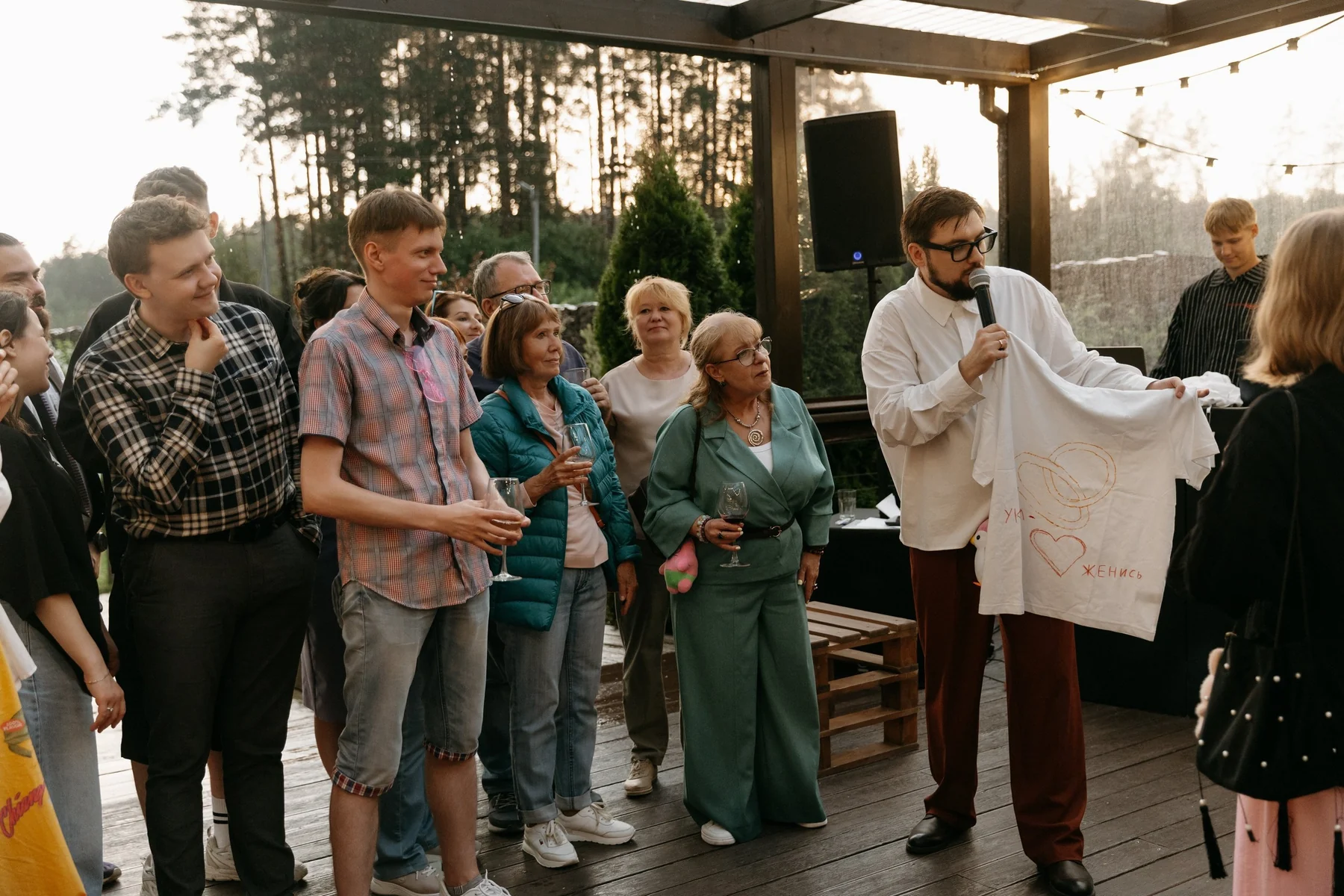 Guests gathered around a speaker during a lively outdoor wedding moment photographed digitally