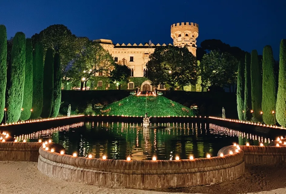 Castell de Sant Marçal illuminated above its garden fountain