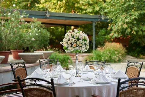 Garden dining setting beneath the trees at Gundel