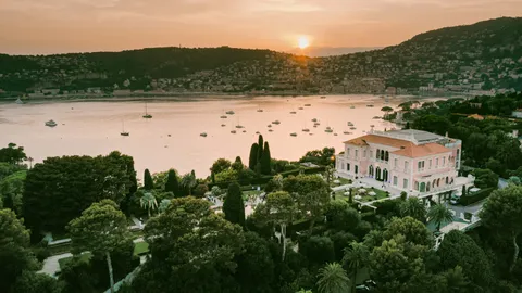 Villa Ephrussi de Rothschild, its gardens and the Mediterranean coast at sunset